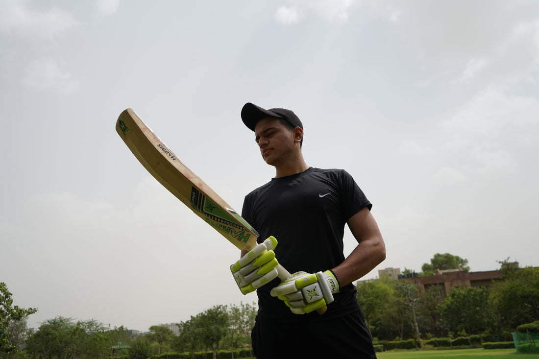 player inspecting a cricket bat grade